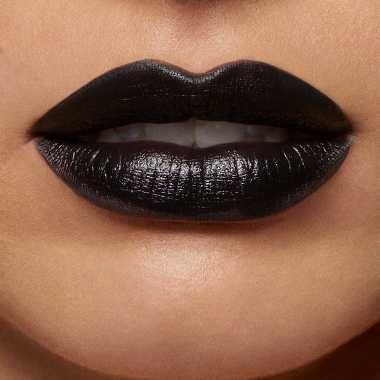 ColourPop Lippie Pencil in Bull Chic lines and fills lips in opaque true black with a soft satin sheen, shown in a tight beauty close-up displaying crisp edges and full coverage.