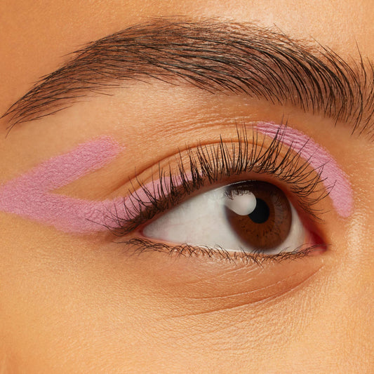 Amethyst Hour ColourPop Crème Gel Liner sweeping in pastel lavender graphic strokes along the upper lid and crease, accenting a brown eye with natural lashes on smooth skin, showcasing the creamy Crème Gel Liner texture.