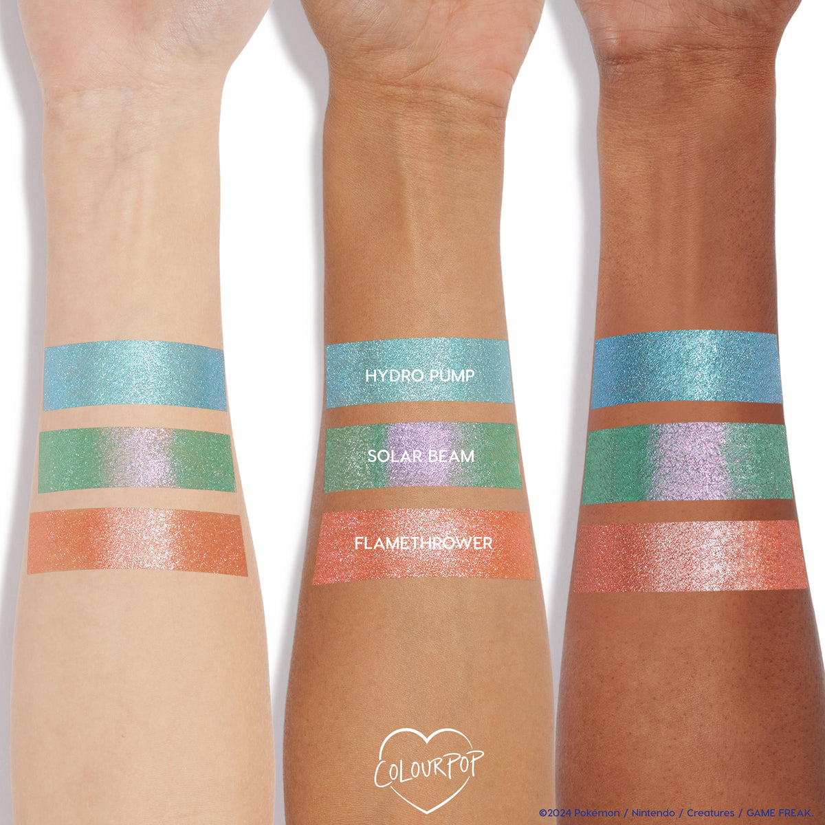 Flamethrower ColourPop Super Shock Shadow swatched in wide stripes on three arms, showing a metallic copper-orange shimmer; placed below Hydro Pump (aqua) and Solar Beam (green‑lavender) to compare pigment and sparkle across light to deep skin tones.