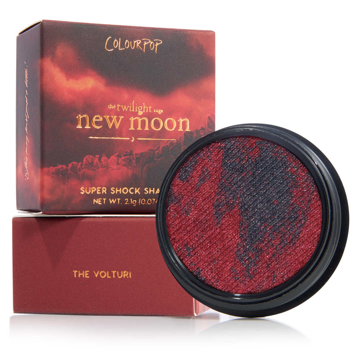 The Volturi eyeshadow single displays marbled crimson and charcoal shimmer in a round black pan, set beside Twilight Saga: New Moon box and matching sleeve, ColourPop Super Shock Shadow (2.1 g) on a white background.