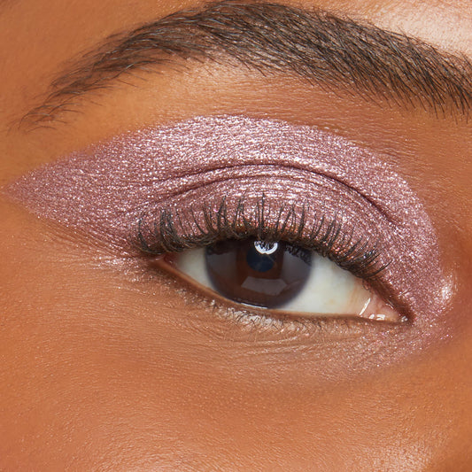 Close-up eyelid wears a shimmery metallic rose-mauve wing, showcasing ColourPop Shadow Stix in Next Spot; creamy stick shadow glides on smoothly with high-shine payoff and even coverage on brown skin for quick, long-wear eye looks.