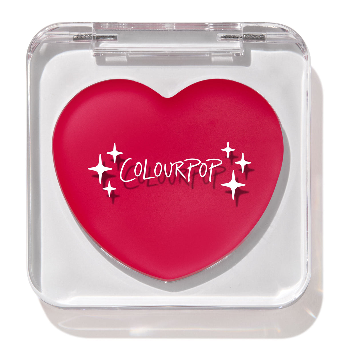 Heart-shaped hot pink compact with white “ColourPop” logo and sparkles rests closed in a clear square case, featuring the ColourPop Lip and Cheek Balm in Girls Night, a rosy multitasking balm for lips and cheeks.