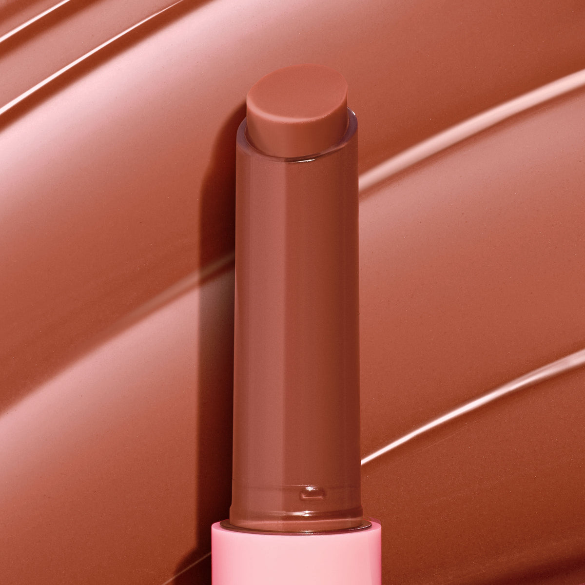 PSL balm stick displays a twist-up, rounded bullet in a warm pumpkin-spice nude against matching glossy swatches; ColourPop So Juicy Plumping Gloss Balm with Peptides showcases a creamy, plumping finish in a pink-accented tube.