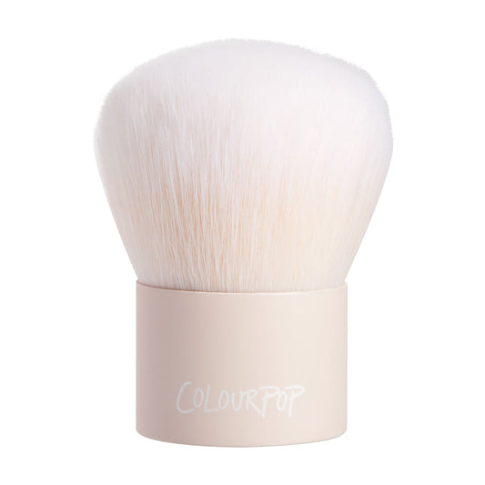 Kabuki Face & Body Brush showcasing dense, dome-shaped white bristles fanning from a short matte nude handle with ColourPop logo, upright on a white background, a ColourPop Makeup Brush for buffing and blending face and body powders.