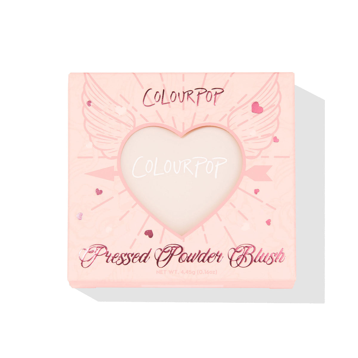 ColourPop Kiss 'N Tell pressed powder blush compact displays through a heart-shaped window in a pink box with winged-heart graphics, front-facing on a white background, 4.45g (0.16 oz) makeup packaging for US shoppers.