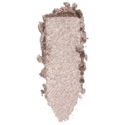 ColourPop I Heart This Super Shock Shadow swatch, a metallic champagne‑taupe with silver glitter, shown as a thick vertical smear with textured, crumbled edges on a white background to highlight its high-shine finish.