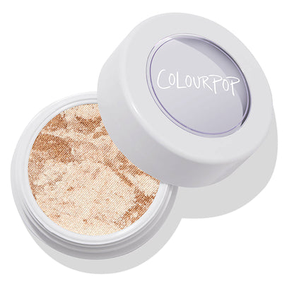 ColourPop Churro Super Shock Highlighter - an open white pot revealing a marbled champagne and warm gold shimmer pan - catching light as the clear lid with ColourPop logo rests ajar on a clean studio background.