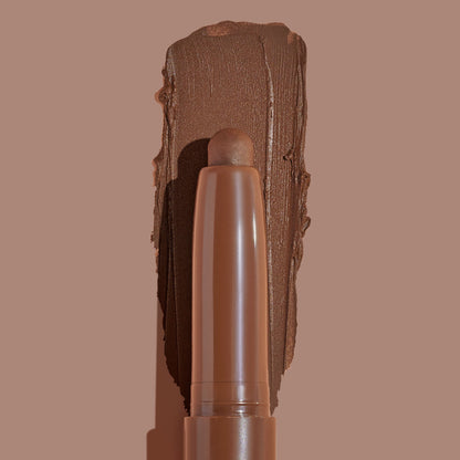 Walnut Ave ColourPop Shadow Stix sweeping a thick, matte walnut-brown swatch on a taupe background, showing the twist-up cream eyeshadow pencil tip and rich pigment payoff for easy, on-the-go eye color.
