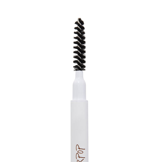 Champagne Blonde Pencil brow pencil by ColourPop, spoolie end standing upright in a macro close-up, black spiral bristles on a white tube against a clean white background for shaping and blending brows.