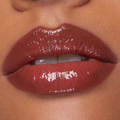 Glossy mauve-brown lips showcase Smooches, the ColourPop So Juicy Plumping Lip Liner & Balm Set, softly parted to reveal a high-shine, fuller look in a close-up studio beauty shot highlighting smooth texture and precise liner.