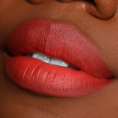 Matte, terracotta-red lips showcasing the Love Bug shade, lined and filled with the ColourPop Lippie Pencil, captured in a tight studio close-up to highlight smooth texture and precise edges for this Lippie Pencil product.
