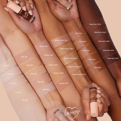 ColourPop Pretty Fresh Creamy Concealer in Fair 05 W swatched on an arm and compared across multiple skin tones, with a peach-capped tube held in hand against a soft beige background to showcase the full shade range.