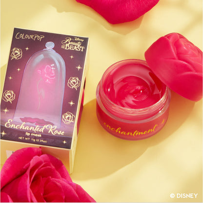 Beautiful Belle Disney Princess lip mask and ultra glossy lip bundle displayed in a flatlay, featuring a rose-shaped pink jar with matching lid beside themed packaging and scattered rose petals on a soft yellow background.