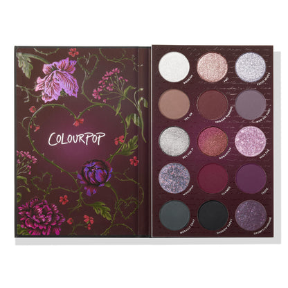 ColourPop A Shadow of Secrets shadow palette opens to reveal a 15-pan mix of mauve, plum, silver, and black shades in matte, shimmer, and glitter finishes, set in a burgundy floral case with a thorny heart - ColourPop Shadow Palette.