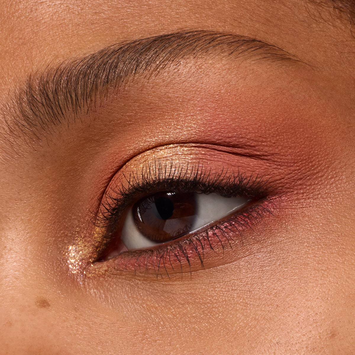 Close-up eyelid showcases peachy-gold shimmer and soft coral mattes from the Baby Got Peach ColourPop Shadow Palette, with metallic inner-corner pop and smoked peach lower lash line for a warm, wearable summer eye look.