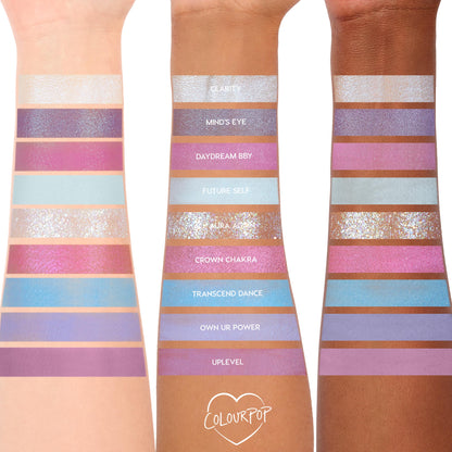 ColourPop In A Trance shadow palette swatches spanning three arms, showcasing pastel purples, pinks, and icy blues in matte, shimmer, and glitter finishes; shade names like Clarity, Mind’s Eye, Daydream BBY, Future Self, and Aura Again visible.