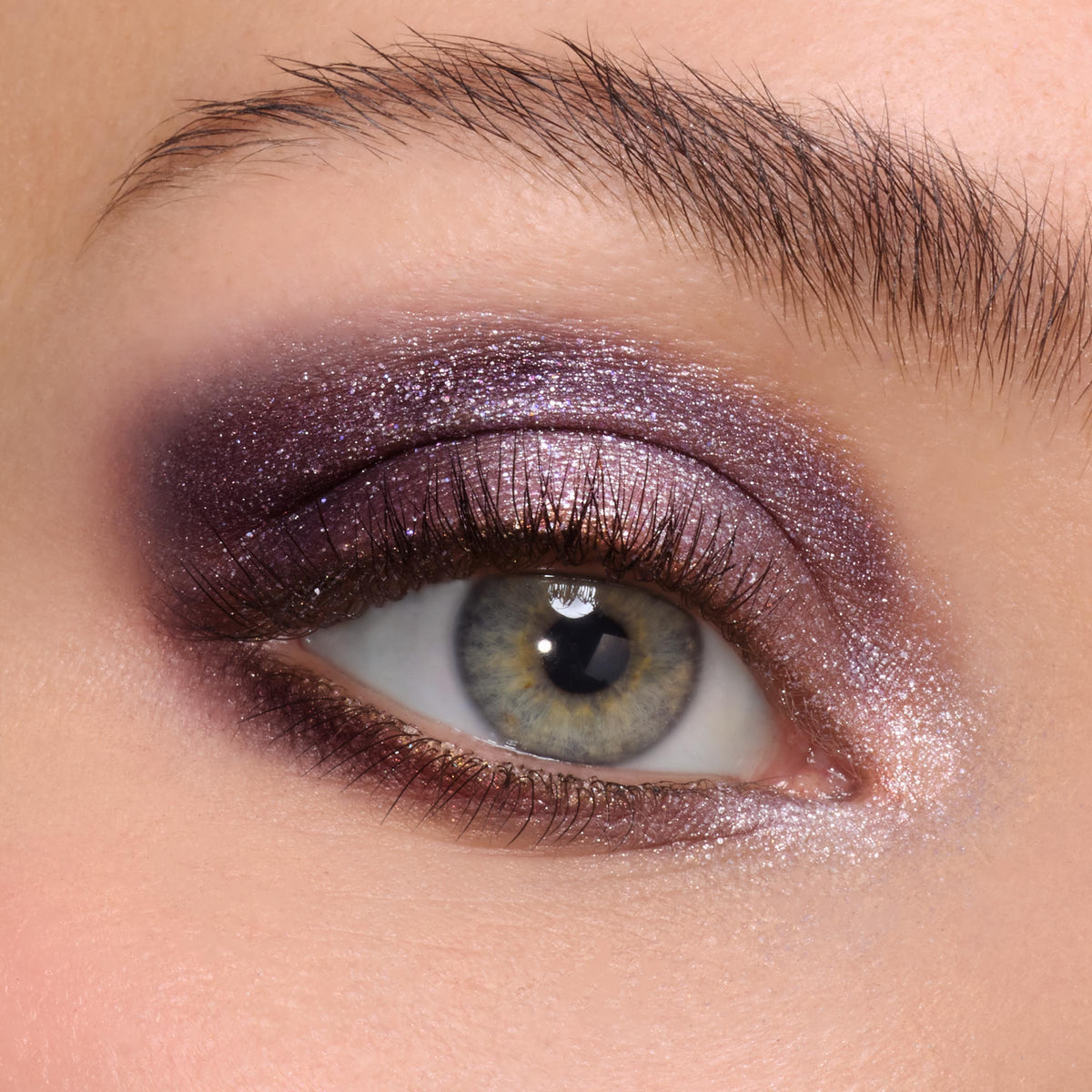 Smoky, glittery icy plum eyeshadow sweeping across the lid and lower lash line with a bright inner-corner highlight, showcased on a close-up eye to demo A Shadow of Secrets Shadow Palette, a ColourPop Shadow Palette for cool-toned, high-shine looks.