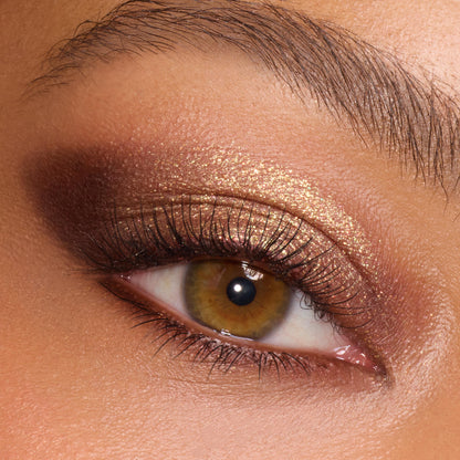 Bronze-gold metallic eyeshadow catches light on a close-up eye, blended into a deep brown smoky outer corner, showcasing the New Moon shadow palette, a ColourPop Shadow Palette, for warm neutral glam with defined lashes.