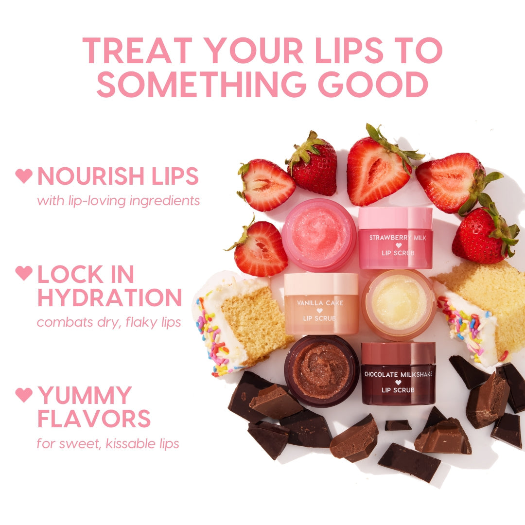 Vanilla Cake ColourPop Lip Scrub shown open with sugar crystals, arranged beside Strawberry Milk and Chocolate Milkshake scrubs, while sliced strawberries, funfetti cake, and dark chocolate pieces frame the set to suggest sweet, hydrating lip care.
