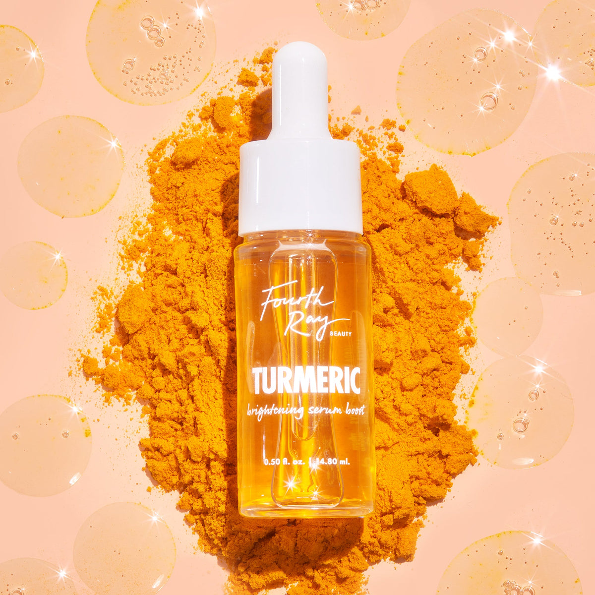 Turmeric Serum face serum bottle with a white dropper cap stands on a mound of turmeric powder, filled with golden liquid and surrounded by glossy serum drops on a peach background; Fourth Ray Beauty 0.50 fl oz ColourPop Face Serum.
