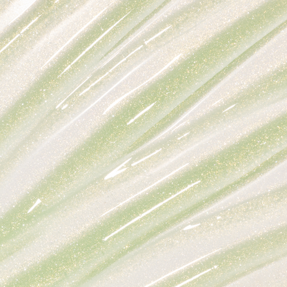 Colourpop Fresh Kiss Glossy Balm in Vanilla Matcha swatched as sheer gold and pale green lip gloss & lip oil with fine gold and silver sparkle streaks across the background, showcasing its shimmery, high-shine finish.