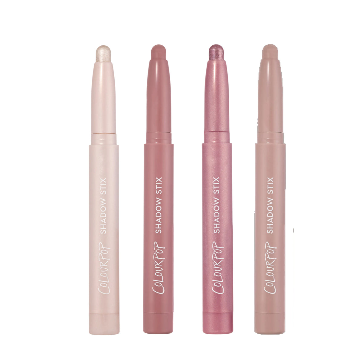 Four ColourPop Heart to Get All Eyes On Me Shadow Stix standing upright in a row on a white background, showing creamy neutral and pink shimmer shades in twist-up eye crayon tubes for easy all-over lid application.
