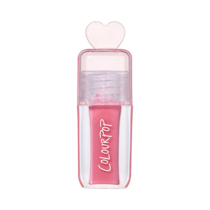 ColourPop Still That Girl ultra glossy lip in pink, standing upright with a clear rectangular tube, heart-shaped cap, and Heart to Get inspired packaging on a clean white background for a modern makeup product shot.