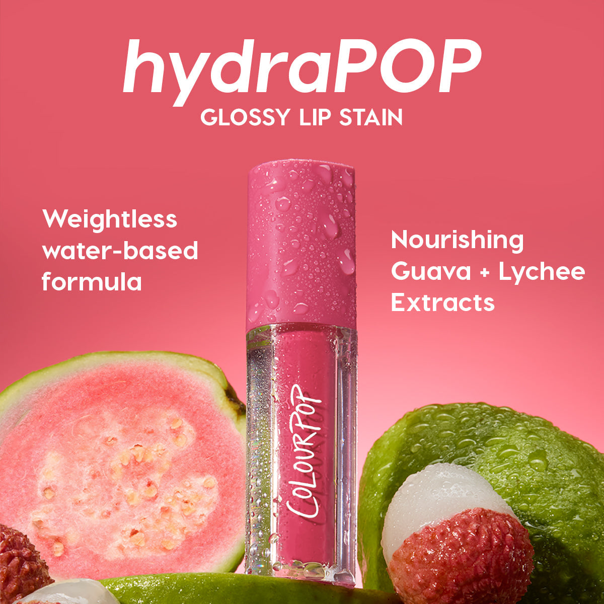 Baby Fox ColourPop Lip Stain hydraPOP glossy tube, beaded with dew, stands among fresh guava and lychee on a pink backdrop, highlighting guava + lychee extracts and a weightless water-based, hydration-infused color in vibrant pink.