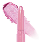 ColourPop Shadow Stix Juicy Gossip shows its rounded bullet tip with a wide swipe of creamy, shimmery cool pink behind it, highlighting the metallic finish and twist-up crayon design on a clean white background.