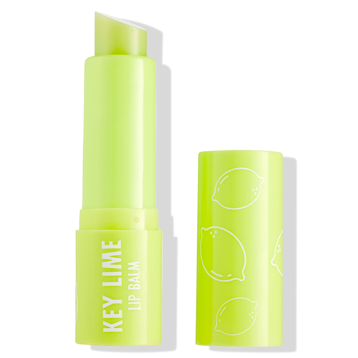 Key Lime ColourPop Lip Balm tube stands uncapped, revealing a slanted balm stick, in neon lime-green packaging printed with white citrus icons and KEY LIME LIP BALM text, with the matching cap beside it on a white background.