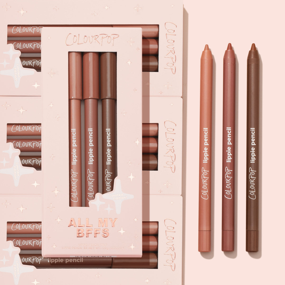 All My BFFs ColourPop Lippie Pencil 3-pack displays three nude lip liner shades - peach, rosy mauve, and deep brown - arranged beside a blush-pink limited-edition box on a soft pink flat lay, highlighting creamy, sharpenable pencils.