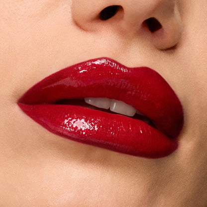 Glossy cherry-red lips showcase Pack Member ColourPop Lip Set, delivering rich pigment and a high-shine finish, captured in an extreme close-up against smooth skin for a bold, vampy look.