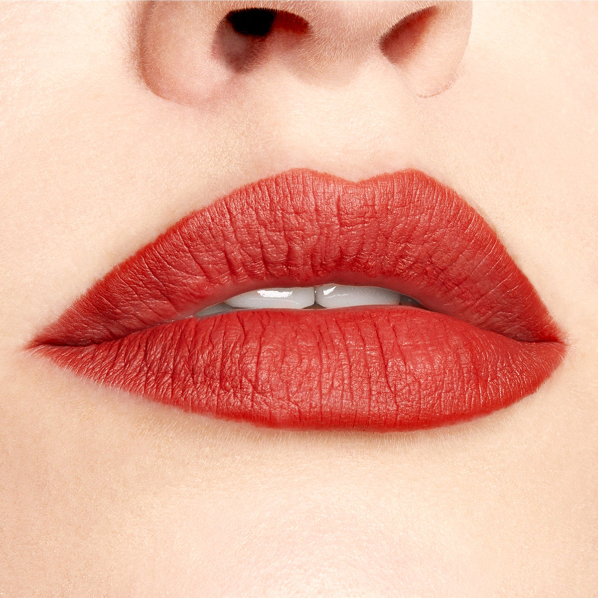 Full lips lined and filled with ColourPop Lippie Pencil Love Bug, showcasing a matte warm terracotta-red finish in a close-up studio shot with smooth, precise edges.