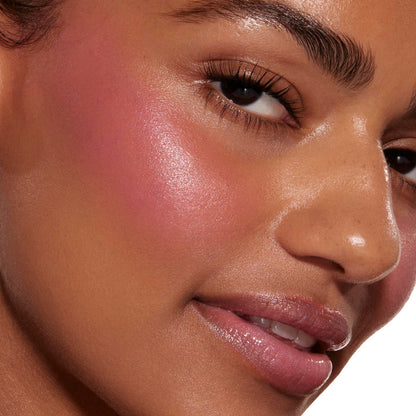 Sweet Treat ColourPop Liquid Blush tinting a model’s cheek with a dewy, luminous pink flush, seamlessly blended along the cheekbone; tight close-up shows smooth skin, glossy lips, and defined lashes for context.