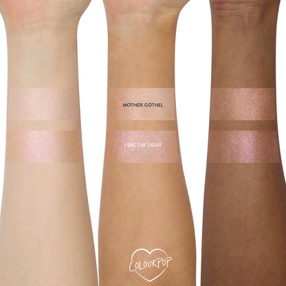 Mother Gothel ColourPop Liquid Highlighter swatched in two shimmering bands on three arms (light, medium, deep tones), showing a rosy champagne glow beside I See The Light on a white background.