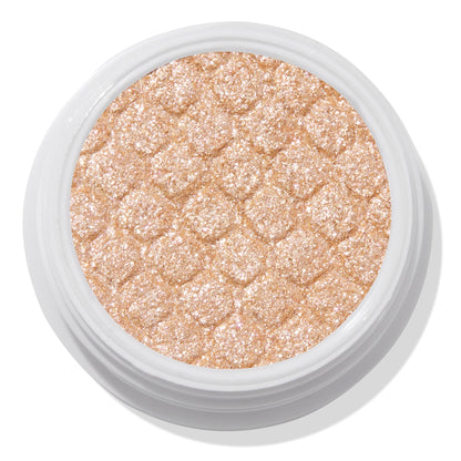 Mighty Morphin’ ColourPop Super Shock Shadow shimmers in a metallic champagne-gold, pressed with a quilted texture in an open white pot, close-up on a white background.