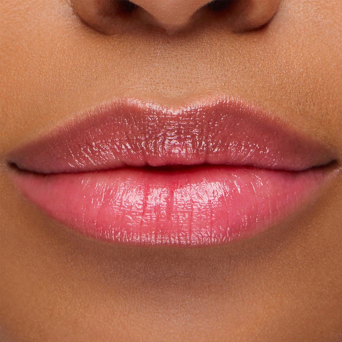 Glossy lips wearing Sing, a ColourPop pH Lip Balm, reveal a soft rosy pink tint that adapts to skin pH, with smooth, hydrated shine in a close-up lip swatch.