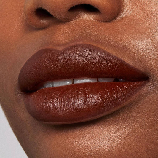 Full lips lined and filled with Pitch, a rich chocolate-brown ColourPop Lippie Pencil, showing smooth, saturated color and sharp definition in a studio close-up.