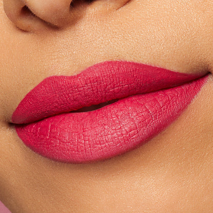 Lips wearing ColourPop Lippie Pencil in I Heart This, lined and filled in a bold fuchsia pink, showcasing a smooth, creamy matte finish in a close-up lip swatch.