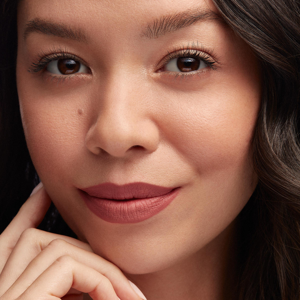 Lips lined and filled with Good N Plenty ColourPop Lippie Pencil, a rosy mauve matte, creating smooth, precise definition; close-up of a model’s face with soft neutral makeup and natural lighting.