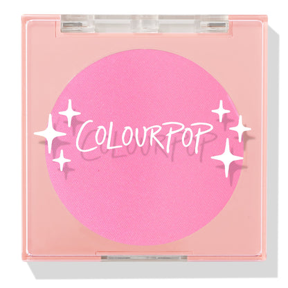 Prairie Air ColourPop Pressed Powder Blush compact sits closed, displaying a vibrant bubblegum pink pan beneath a clear lid with white sparkle icons and the ColourPop logo, housed in a peach square case on a white background.
