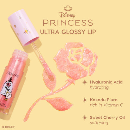 Colourpop Disney Princess Ultra Glossy Lip Belle tube with pink glitter gloss and doe-foot applicator forming a sparkling rose on a beige background, highlighting hydrating hyaluronic acid, vitamin C–rich kakadu plum, and softening sweet cherry oil.