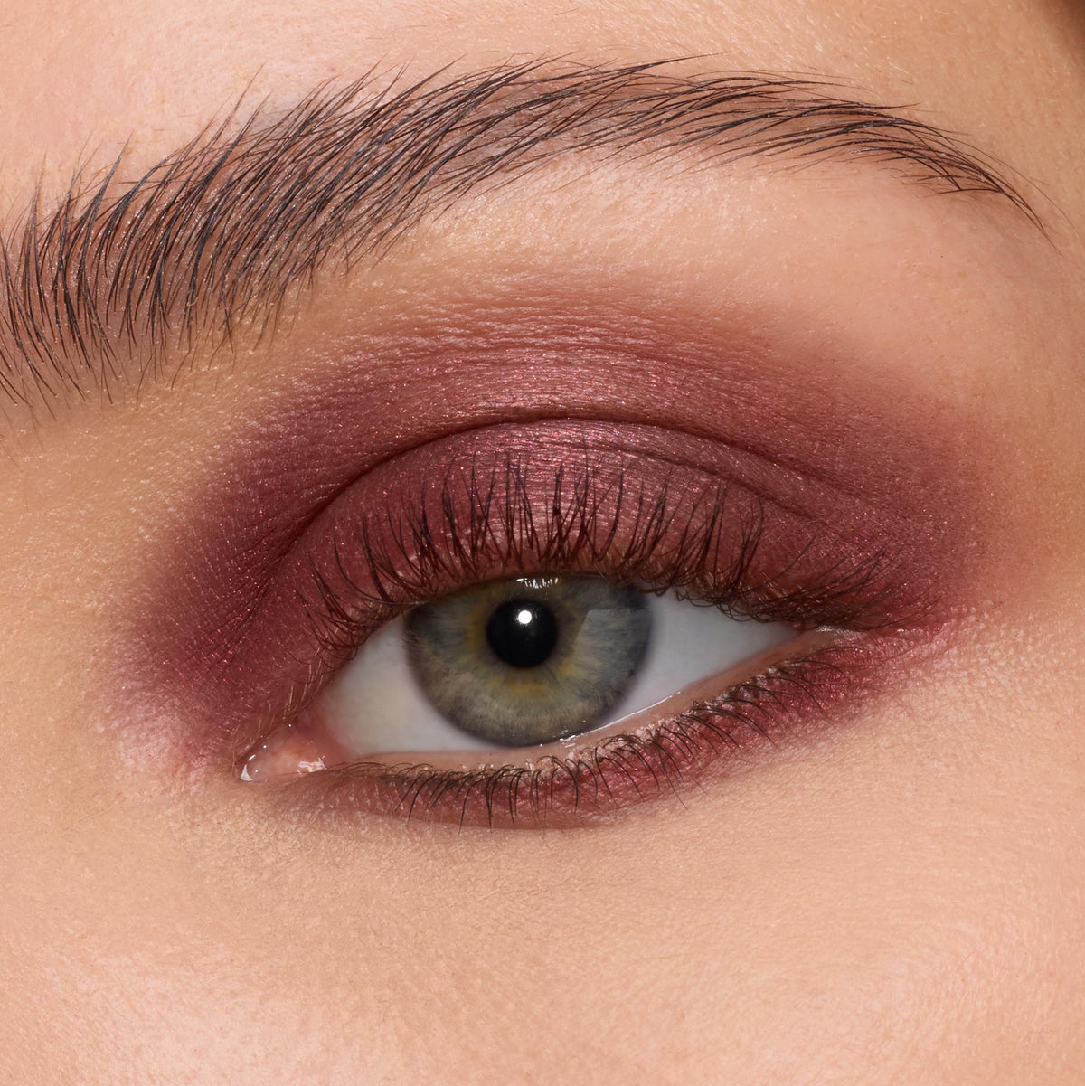 Deep burgundy metallic shadow sweeps across the eyelid and lower lash line, showcasing The Volturi Super Shock Shadow’s smooth, creamy payoff; the ColourPop Super Shock Shadow blends seamlessly with soft shimmer in a close-up eye.
