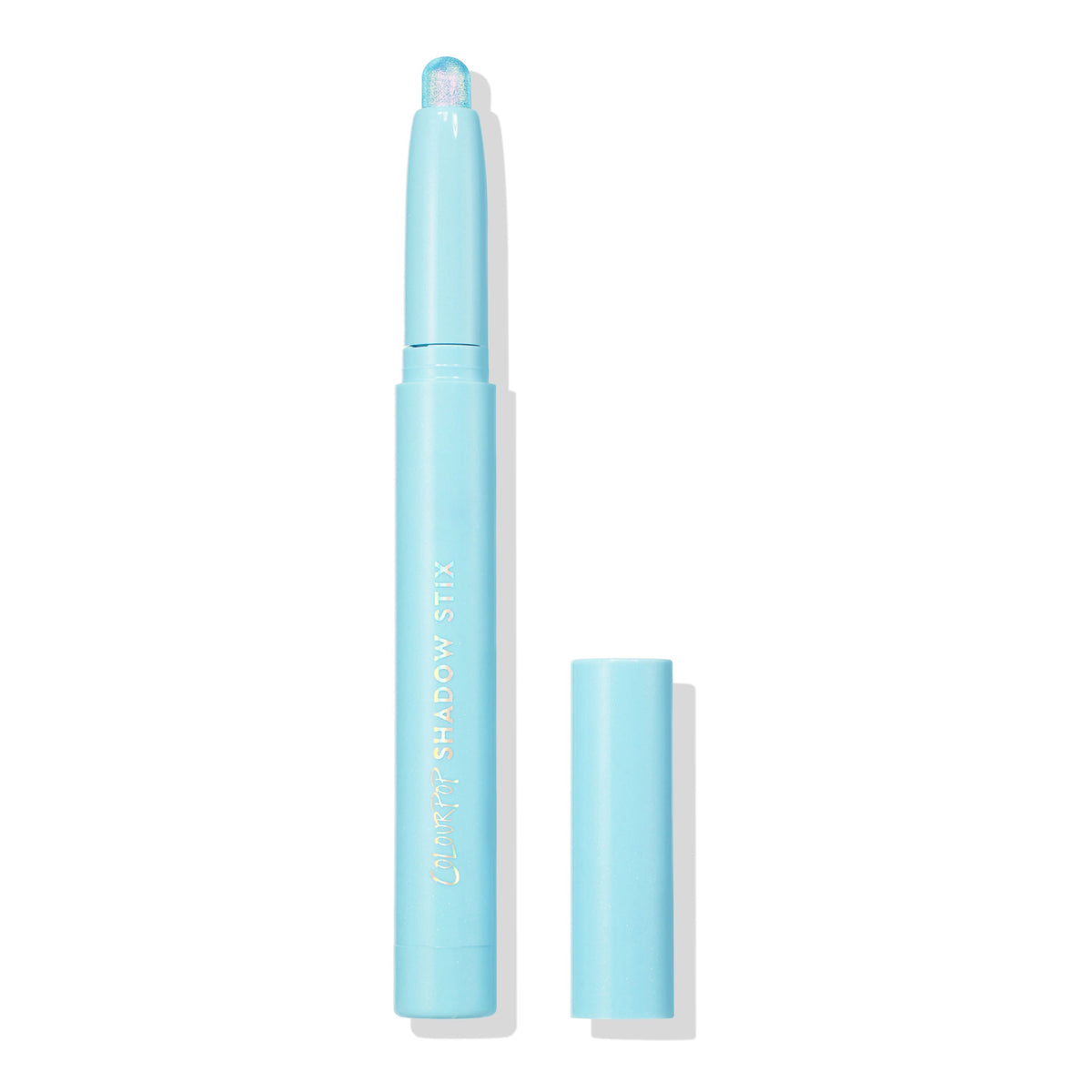 Colourpop Game Over Shadow Stix with shimmering icy blue cream eyeshadow bullet exposed, standing upright with cap off beside it on a clean white background for a minimalist product display.