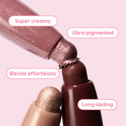 Rose Goals ColourPop Shadow Stix twist-up eyeshadow tips touch in a close-up, showcasing creamy, ultra-pigmented rose and mauve shimmer that blends effortlessly and lasts long, with a champagne shade below and deep berry casing in studio light.