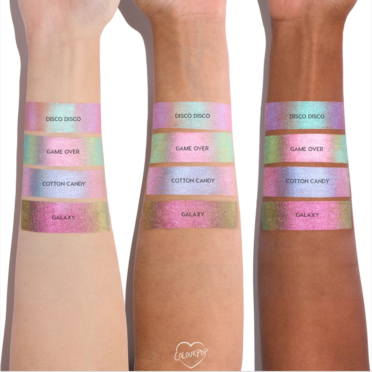 Colourpop Cotton Candy Shadow Stix swatch shown on three arms with different skin tones, displaying its pastel iridescent pink-blue shimmer stripe between other shades in the Shadow Stix collection for comparison.