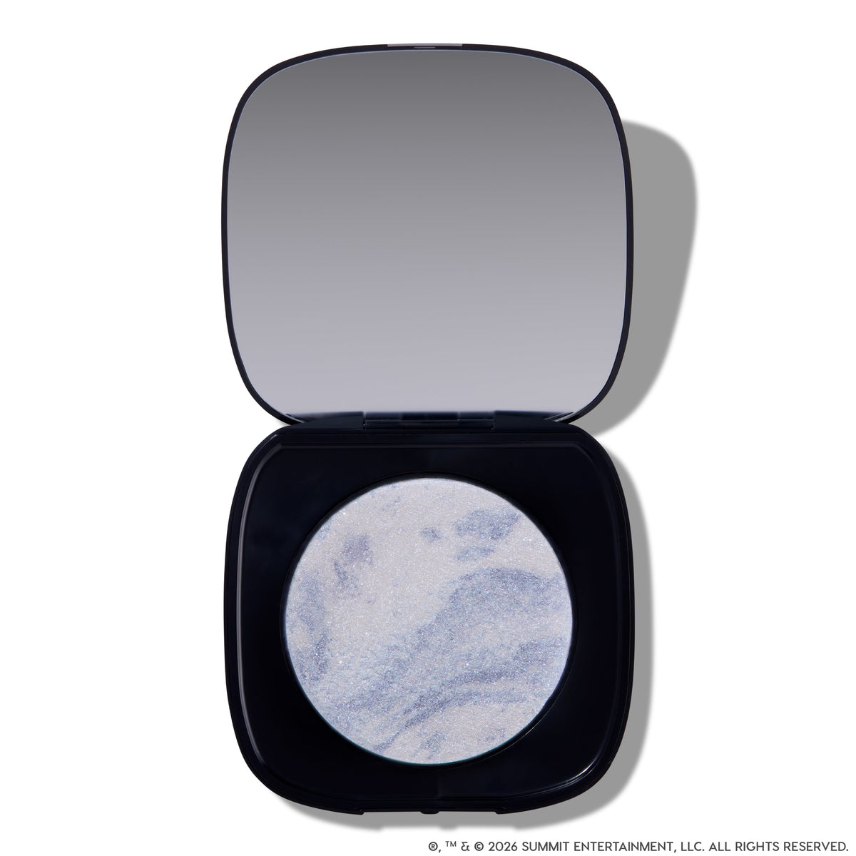 Open compact of Change Me Mega Highlighter with shimmering icy lavender and silver marbled pan set in a sleek black case with mirror, styled on a white background for the Twilight makeup collection.