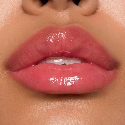 Glossy pink lips showcasing ColourPop Ultra Glossy Lip, shade Experiment 626, catching bright studio light with a glassy finish in a tight close-up beauty swatch.