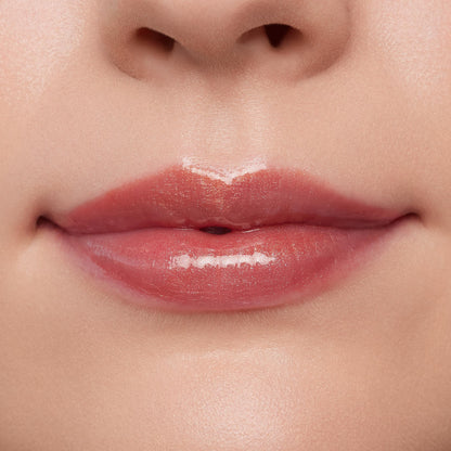 Lips wearing ColourPop Ultra Glossy Lip in Flynn Rider, showing a high-shine sheer rosy nude finish on a close-up model mouth, smooth even coverage and wet-look gloss under studio lighting for a plump, hydrated look.