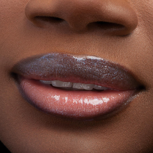 Lips wearing ColourPop Ultra Glossy Lip, Peep This, gleaming with a glassy, high-shine finish and iridescent micro-sparkle; extreme close-up of the mouth highlights smooth, hydrated texture and multidimensional shimmer.